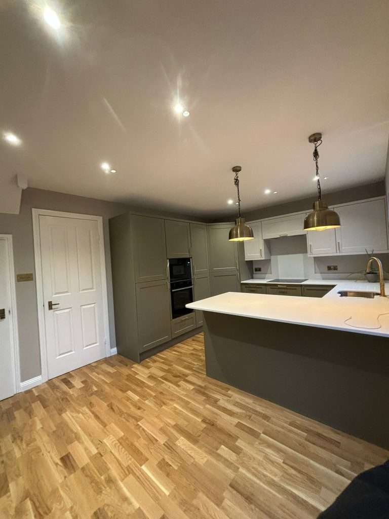 Modern grey kitchen renovation with island and pendant lighting